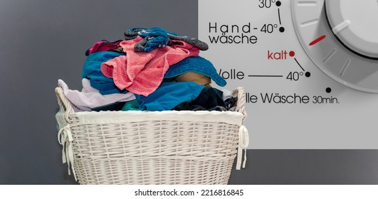 Concept Cold Washing Laundry. Kalt Wäsche In German Language. Basket With Dirty Laundry. Clothes In Rattan Basket. Multicolored Dirty Laundry Ready For Washing