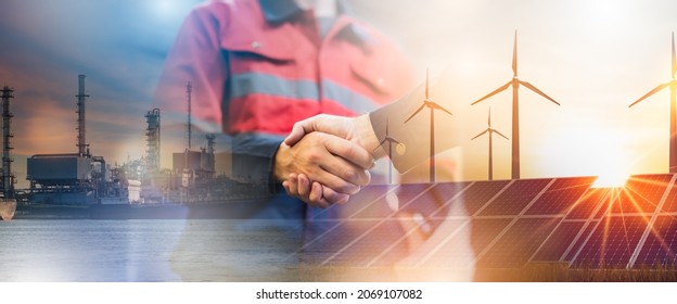 Concept collaboration to change the world to reduce global warming energy sources for renewable sustainability by alternative energy Double exposure handshake wind turbine   night city 