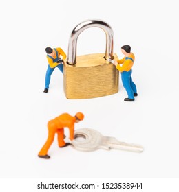 The concept of a collective solution to any problem. Miniature toy workers and security key using as background security system, hack, business concept.