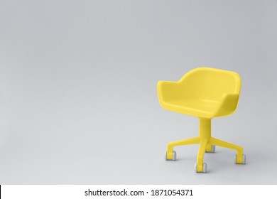 Concept Of Color Of The Year 2021. Illuminating Yellow Stool On Ultimate Grey Clean Background. Photoshoot In Minimal Style.