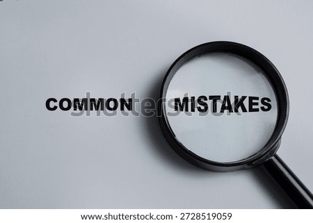 Concept of common mistakes write on book isolated on Wooden Table.