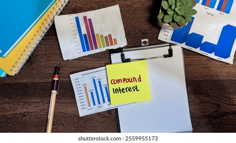 Concept of Compound Interest write on sticky notes isolated on Wooden Table.
