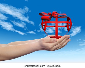 Concept or conceptual 3D red abstract heart sign or symbol with ribbon held in hands by a man, woman or child on blue sky background, metaphor for love, holiday, gift, care, valentine or romantic - Shutterstock ID 236656066