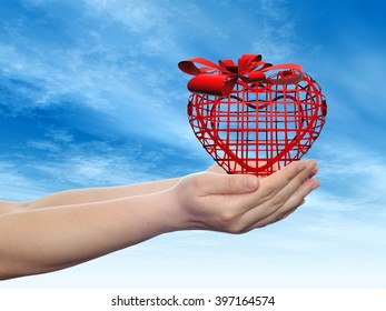 Concept or conceptual 3D red abstract heart sign or symbol with ribbon held in hands by a man, woman or child on blue sky background metaphor for love, holiday, gift, care, valentine or romantic