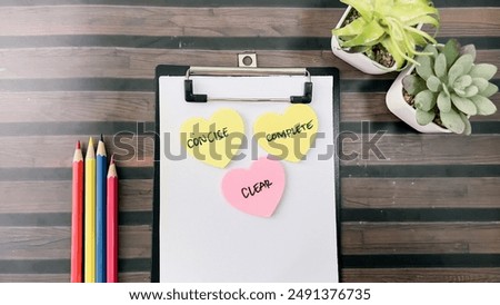 Concept of Concise, Clear, Complete write on sticky notes isolated on Wooden Table.