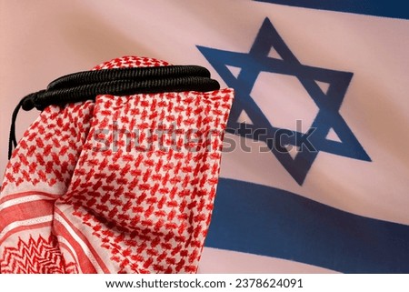 Concept of a Conflict between Isreal and the Palestinian.Hidden man with palestinian scarf over head in front