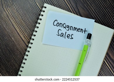 Concept of Consignment Sales write on sticky notes isolated on Wooden Table.
