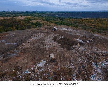 The concept of consumption and pollution. A lot of waste is thrown away. Loaders work on mountain debris. Aerial view and top view. - Powered by Shutterstock