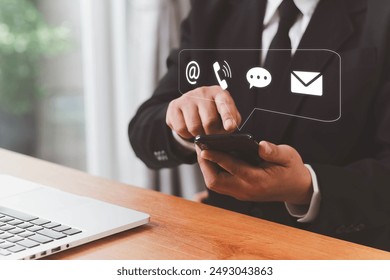 Concept of contact us, customer support, service, icon, Contact us or Customer support hotline people connect. Businessman using a laptop with the (email, call phone, mail) icons. customer service.