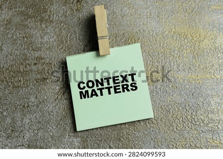Concept of context matters write on sticky notes isolated on Wooden Table.