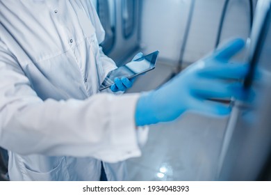 Concept Control Food Industry. Factory Worker Inspecting Production Line Tanker In Of Dairy With Computer Tablet.