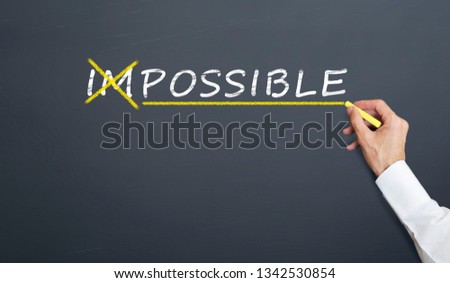 The concept of converting the word impossible to possible. handwriting on blackboard with chalk