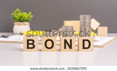 the concept conveyed by the image of wooden blocks spelling BOND with a stack of coins above symbolizes financial financial security, investment opportunities, and wealth accumulation through bonds