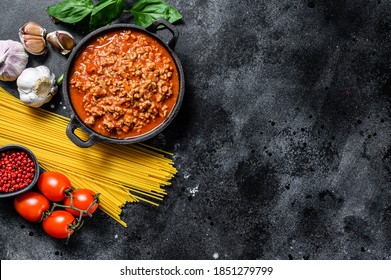 The Concept Of Cooking Pasta Spaghetti With Tomatoes, Sauce Bolognese, Cheese And Basil. Black Background. Top View. Copy Space