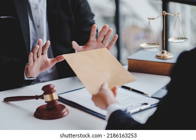 Concept of corruption, bankruptcy court, bail, crime, bribery, fraud, Judge Gavel, soundboard and a handful of cash on the table. - Shutterstock ID 2186163253