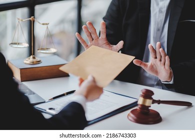Concept of corruption, bankruptcy court, bail, crime, bribery, fraud, Judge Gavel, soundboard and a handful of cash on the table. - Shutterstock ID 2186743303