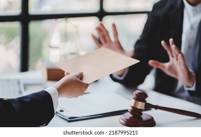 Concept of corruption, bankruptcy court, bail, crime, bribery, fraud, Judge Gavel, soundboard and a handful of cash on the table. - Shutterstock ID 2187995215