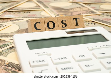 Concept of cost calculation (calculator, 10000 yen note and COST characters)