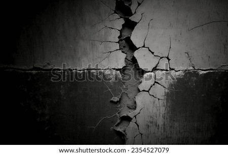 The concept of cracks in the texture of concrete. Cracked concrete wall covered with black cement texture as background for design