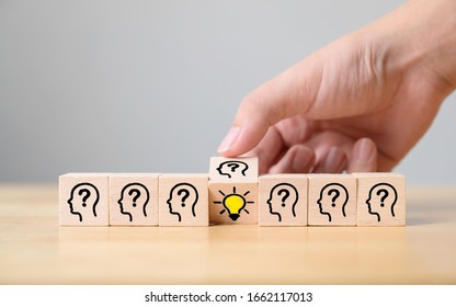 Concept creative idea and innovation. Hand flip over wooden cube block with head human symbol and light bulb icon - Shutterstock ID 1662117013