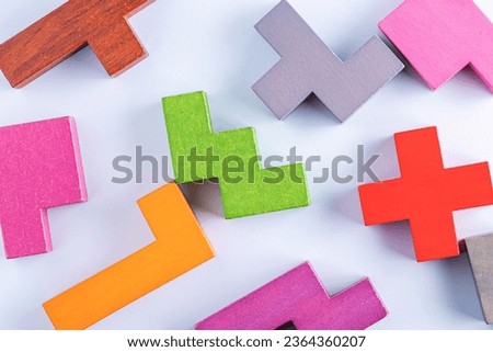Concept of creative, logical thinking. Different colorful shapes wooden blocks on white background, flat lay, copy space. Geometric shapes in different colors, top view. Abstract Background.