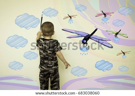 Concept of creativity child. The little boy draws on the wall. Flying dragonflies with clouds in their paws. Fantasy for children. Photo illustration for your design.