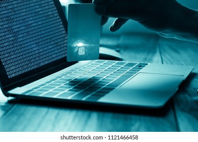 The Concept Of Credit Card Theft. Hackers With Credit Cards On Laptops Use These Data For Unauthorized Shopping. Unauthorized Payments From Credit Card Owners. In The Hacker's Secret Office