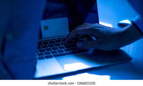 The Concept Of Credit Card Theft. Hackers With Credit Cards On Laptops Use These Data For Unauthorized Shopping. Unauthorized Payments From Credit Card Owners. In The Hacker's Secret Office