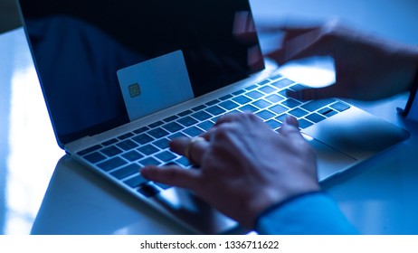 The Concept Of Credit Card Theft. Hackers With Credit Cards On Laptops Use These Data For Unauthorized Shopping. Unauthorized Payments From Credit Card Owners. In The Hacker's Secret Office