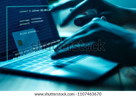 The concept of credit card theft. Hackers with credit cards on laptops use these data for unauthorized shopping. Unauthorized payments from credit card owners. In the hacker's secret office