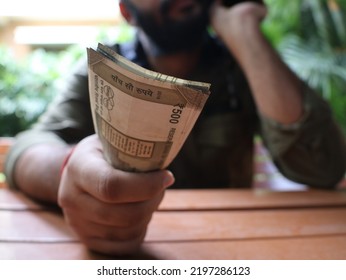 Concept Currency Shot Of Young Guy Holding Of Indian Rupees. Close Up Of A Man Doing Stock Trading Or Dealing Deals. 4K Video. New Indian Currency Notes. 500 Indian Rupee Notes. Paying In Cash.