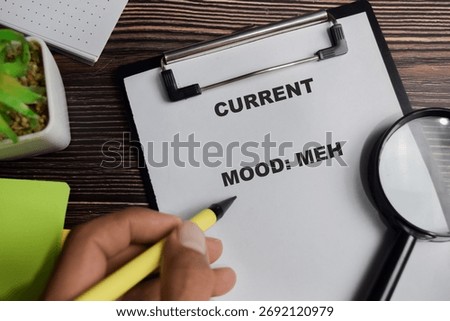 Concept of current mood meh write on clipboard isolated on Wooden Table.