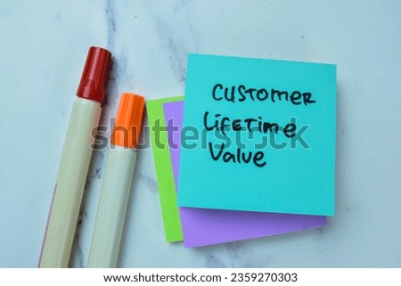 Concept of Customer Lifetime Value write on sticky notes isolated on Wooden Table.