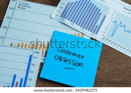 Concept of Customer Obsession write on sticky notes isolated on Wooden Table.