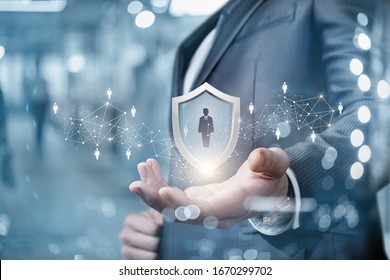 The concept of customer protection. Businessman shows a shield with a silhouette of a man.