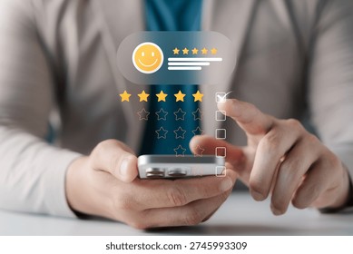 Concept of customer satisfaction and feedback. Close-up of hands using a smartphone to give a five star rating and positive review on a digital holographic interface. Excellent service quality.