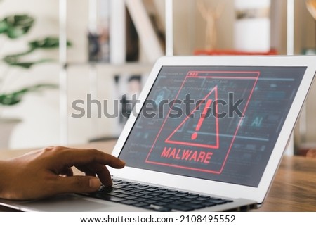 Concept of cyber crime and protection way, laptop showing malware and virus screen, hacking passwords and personal data.