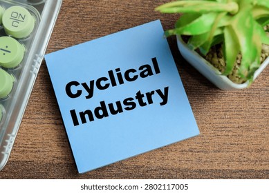 Concept of cyclical industry write on sticky notes isolated on Wooden Table.