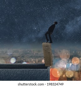 Concept Of Dangerous Balance, Business Man Dancing On A Stone Of The Roof Of City Under Stars In Night.