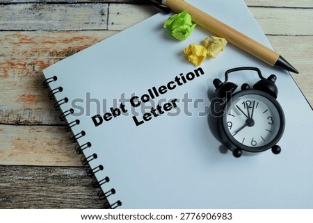 Concept of debt collection letter write on book isolated on Wooden Table