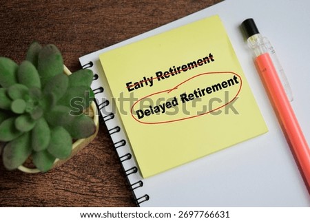 Concept of delayed retirement write on sticky notes isolated on Wooden Table.