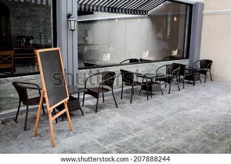 Concept and design front of Coffee Shop with black board and black seating