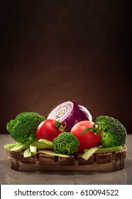 Concept Design Image For A Cookbook Or Magazine Cover Vegetables On A Wooden Platter On A Dark Background