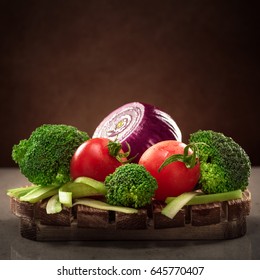 Concept Design Image For A Cookbook Or Magazine Cover Vegetables On A Wooden Platter On A Dark Background