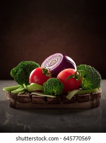 Concept Design Image For A Cookbook Or Magazine Cover Vegetables On A Wooden Platter On A Dark Background