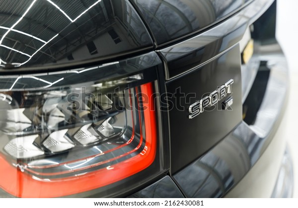The\
concept of detailing. Headlight of a modern car. Car brake light.\
Close-up of rear light or tail lamp. Black premium urban crossover,\
luxury SUV rear light. The inscription -\
sport.