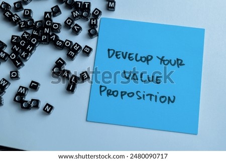 Concept of Develop Your Value Proposition write on sticky notes isolated on Wooden Table.