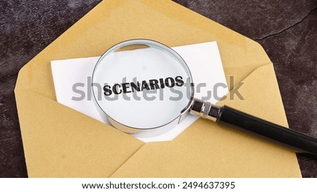 The concept of developing scenarios and action plans. SCENARIOS through a magnifying glass on a piece of paper sticking out of an envelope. Concept photo