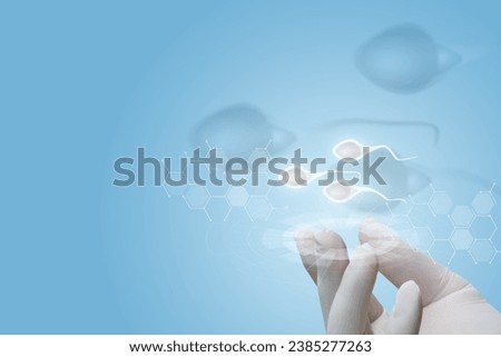 Concept of diagnosis and research of sperm donors. Hand shows sperm on a blue background.