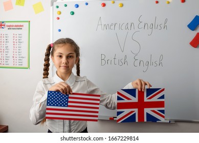 Concept Of Difference Between American English And British English. Young Learner Showing Flags Of USA And United Kingdom Against Board With Inscription American English VS British English